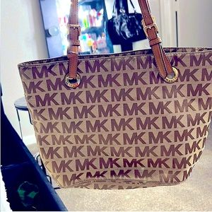 This is a Michael Kors Tote in MK monogram cloth, in good shape